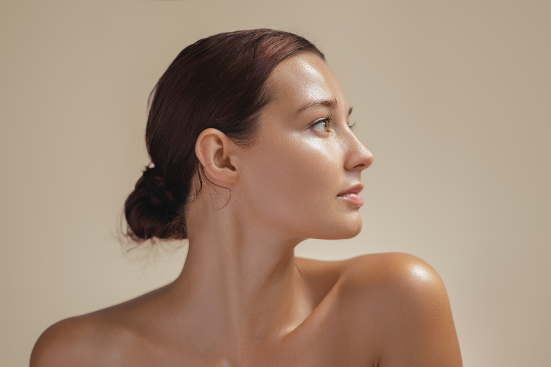 Close-up side profile of a woman with glowing skin, showcasing natural beauty after medspa treatment.