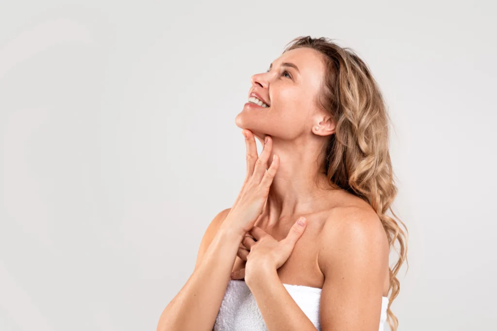 A confident woman showcasing her slim chin and jawline after Kybella treatment.