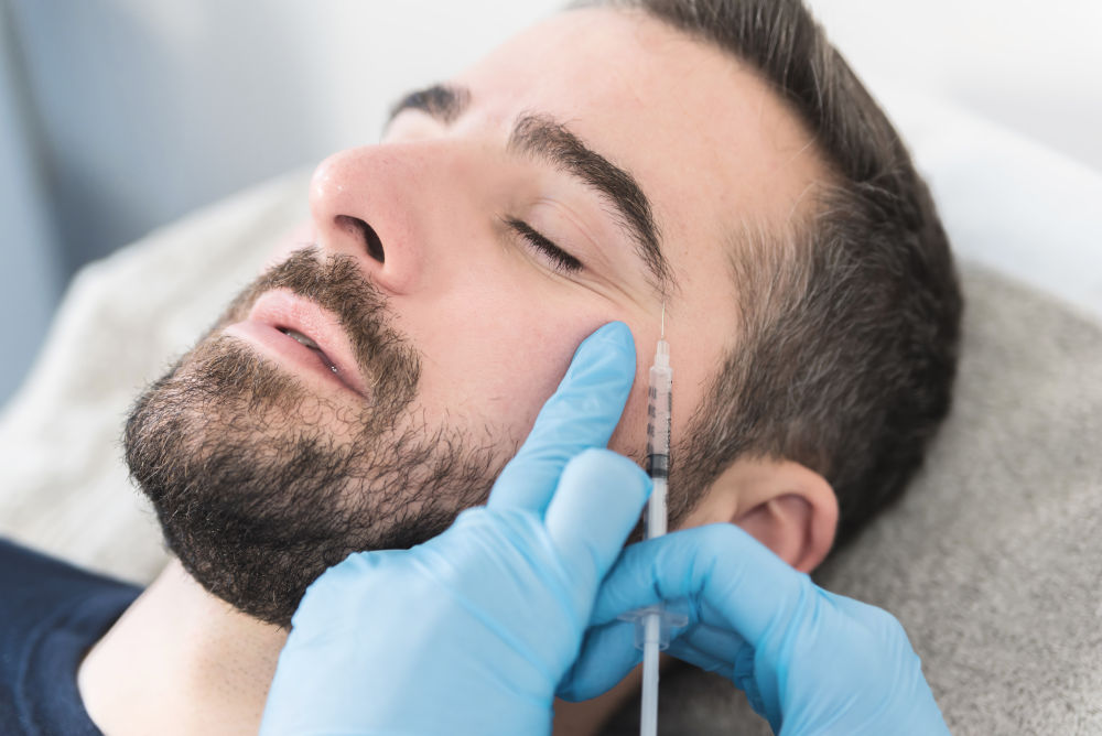 Man receiving Botox injection near the eye