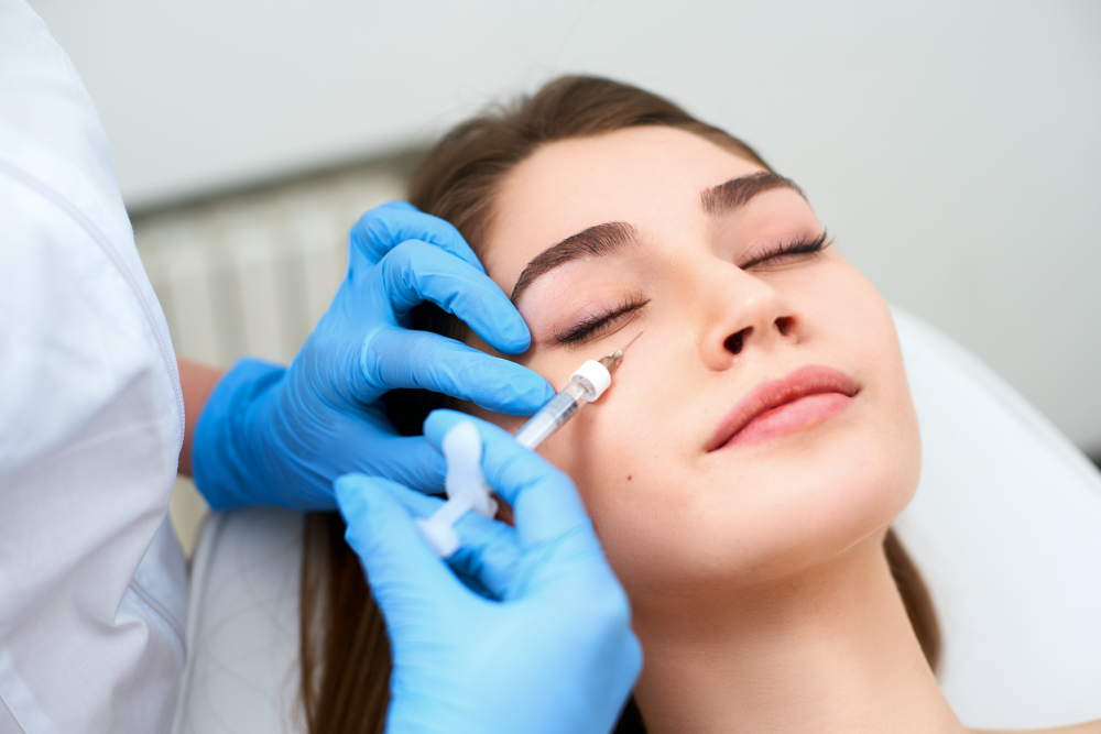A woman receiving under-eye injections at a med spa.